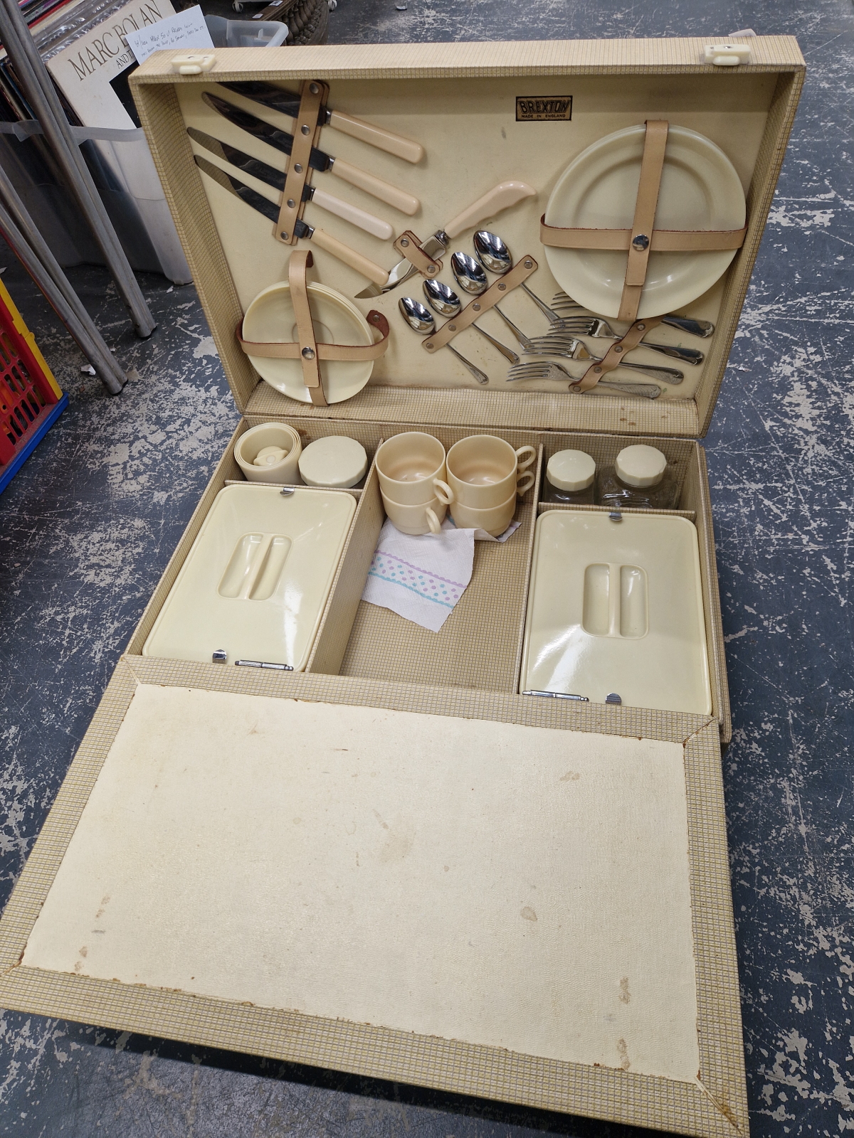 A CASED YELLOW PLASTIC PICNIC SET