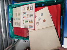 A COLLECTION OF ALBUMS CONTAINING WORLD WIDE POSTAGE STAMPS