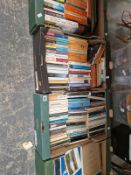 FOUR TRAYS OF PAPERBACK BOOKS