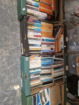 FOUR TRAYS OF PAPERBACK BOOKS