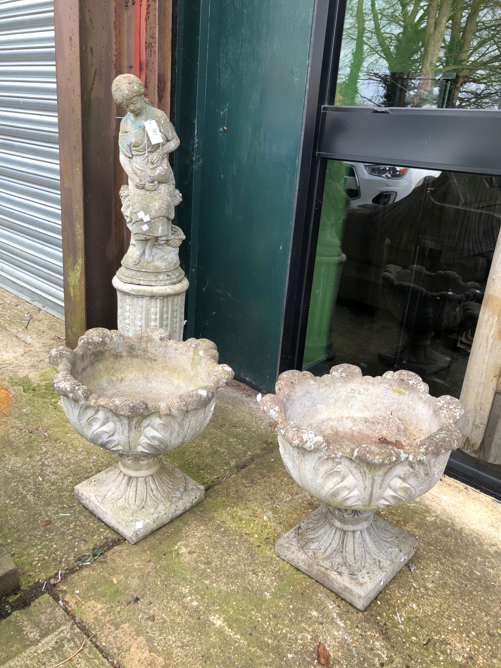 A PAIR OF RECONSTITUTED STONE GARDEN URNS TOGETHER WITH A FIGURE ON A COLUMN