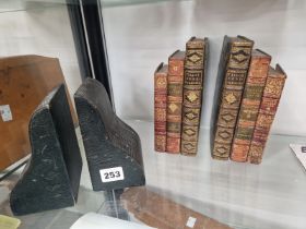 A PAIR OF BOOKENDS IN THE FORM OF THREE LEATHER BOUND BOOKS TOGETHER WITH ANOTHER PAIR IN BLACK