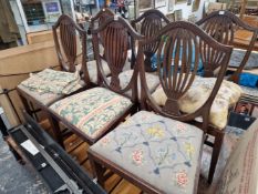 A SET OF SIX MAHOGANY SHIELD BACKED CHAIRS WITH NEEDLE WORK DROP IN SEATS