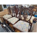 A SET OF SIX MAHOGANY SHIELD BACKED CHAIRS WITH NEEDLE WORK DROP IN SEATS