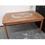 A MID CENTURY TEAK AND TILE TOP EXTENDING DINING TABLE.