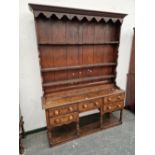 A 19th C. OAK DRESSER WITH AN ENCLOSED THREE SHELF BACK AND A FIVE DRAWER BASE ON BALUSTER TURNED