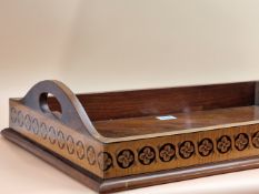 A MAHOGANY TWO HANDLED TRAY, THE SATIN WOOD EXTERIOR OF THE GALLERY INLAID WITH GUILLOCHE ROUNDELS