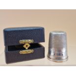 A CASED SILVER THIMBLE SHAPED MEASURE, BIRMINGHAM 1973, THE RIM INSCRIBED JUST A THIMBLEFUL,