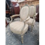 A PAIR OF GREY PAINTED FAUTEUILS, THE OVAL BACKS UPHOLSTERED WITHIN BEADED FRAMES, THE TAPERING