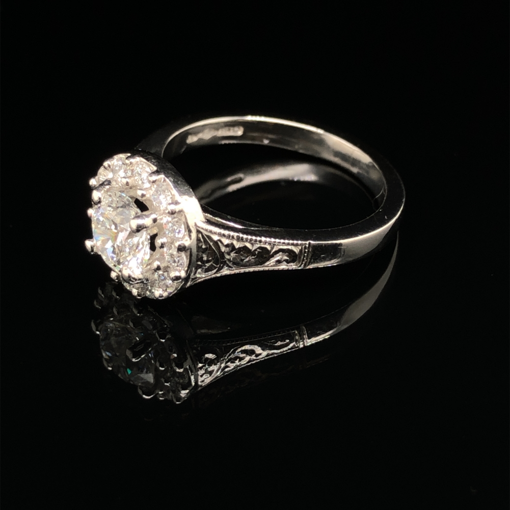 A GIA ROUND BRILLIANT CUT DIAMOND AND PLATINUM RING. THE CENTRE DIAMOND 0.71cts, SURROUNDED BY A - Image 5 of 10