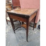 AN EDWARDIAN MARQUETRIED ROSEWOOD ENVELOPE GAMES TABLE