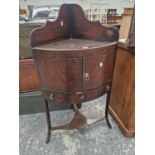 A REGENCY MAHOGANY CORNER WASH STAND.