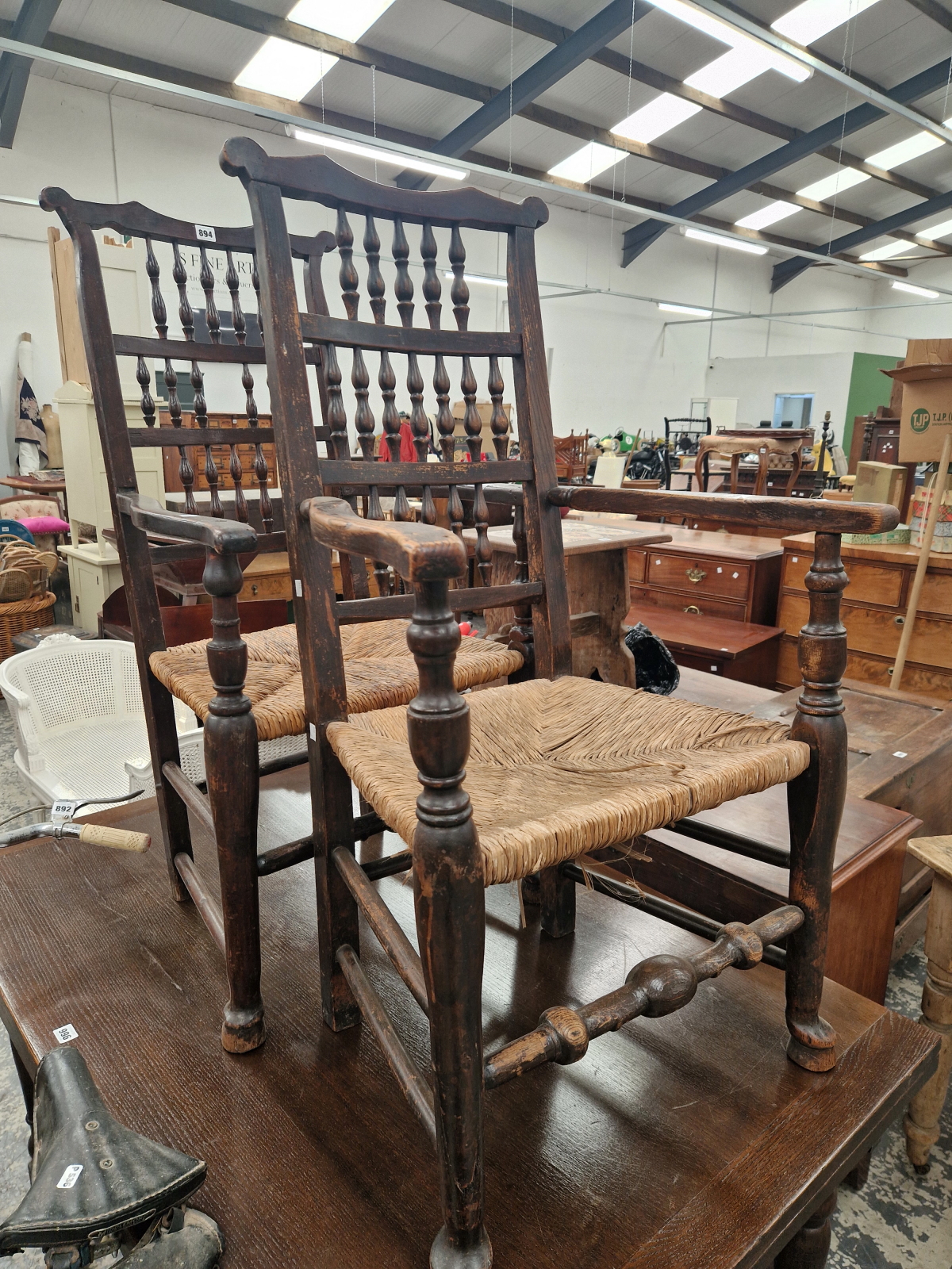 A PAIR OF COUNTRY ELBOW CHAIRS, THE BACKS WITH THREE ROWS OF SPINDLES