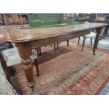 A LATE VICTORIAN MAHOGANY RECTANGULAR DINING TABLE WITH ONE LEAF, THE FOUR FLUTED CYLINDRICAL LEGS