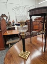 TWO OIL LAMPS WITH CLEAR GLASS RECEIVERS AND ON REEDED COLUMN BASES