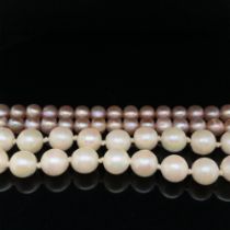 TWO STRINGS OF CULTURED PEARLS. A PINK 82cm ROPE WITH A 9ct HALLMARKED GOLD CLASP, AND A FURTHER