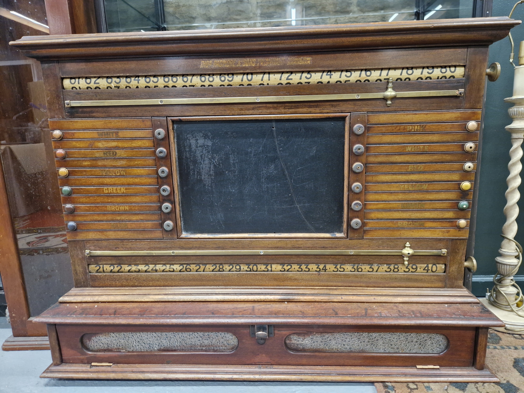 A MAHOHANY SNOOKER SCORE BOARD, WITH A CENTRAL BLACK BOARD AND A GLAZED PULL DOWN DOOR TO A
