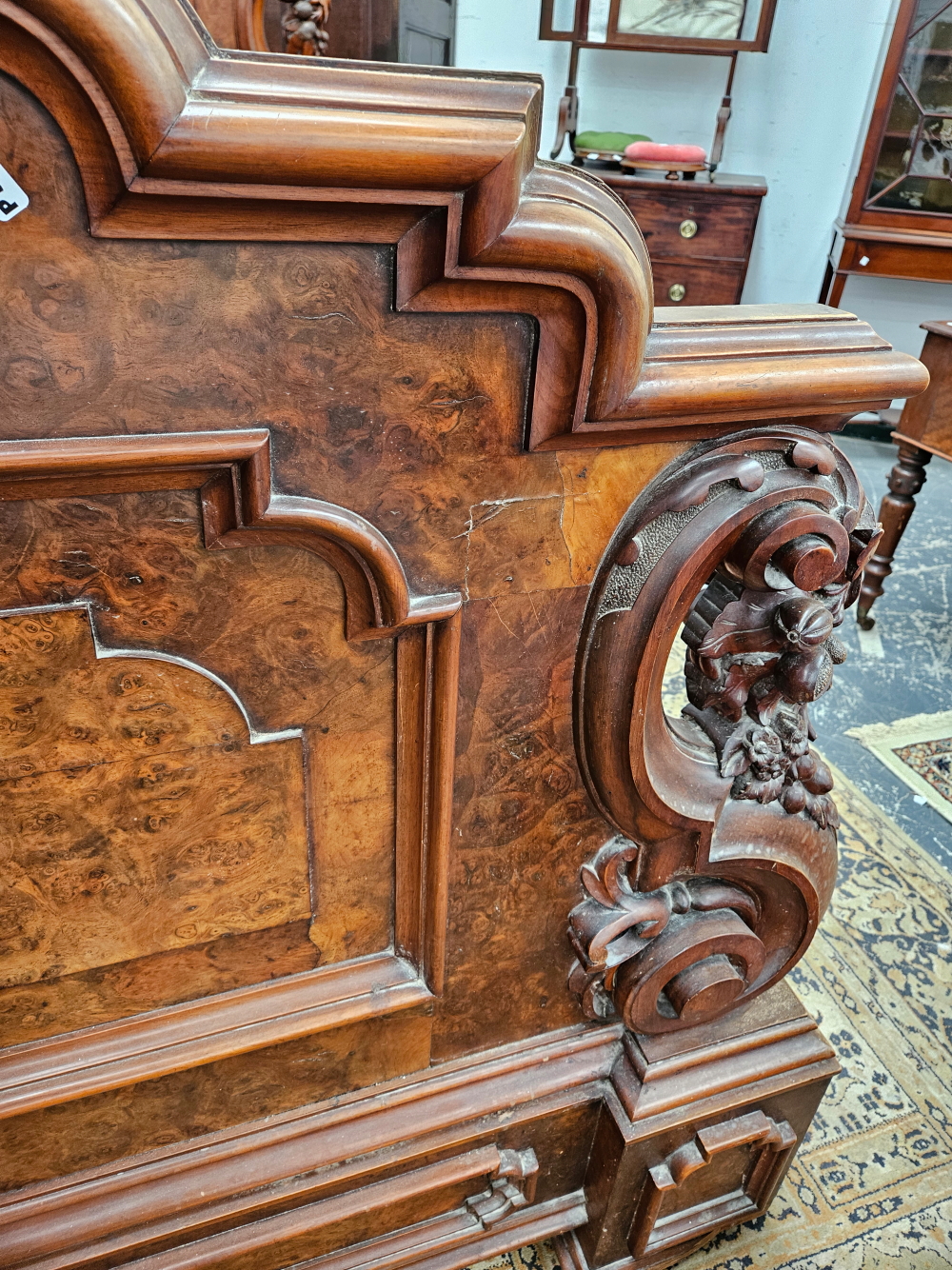 A LATE VICTORIAN BURR WALNUT DOUBLE BED WITH PANELLED ENDS FLANKED BY SCROLLING BRACKETS CARVED WITH - Image 7 of 8