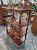 A VICTORIAN  MAHOGANY FOUR TIER BUFFET WITH FOLIATE CARVED THREE QUARTER GALLERIED TOP