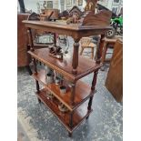 A VICTORIAN  MAHOGANY FOUR TIER BUFFET WITH FOLIATE CARVED THREE QUARTER GALLERIED TOP