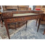 A MAHOGANY CARLTON HOUSE DESK, THE GALLERIED BACK ABOVE FIVE LINE INLAID DRAWERS BEFORE THE GREEN