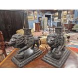 A PAIR OF BRONZE LION TABLE LAMPS, EACH STANDING WITH A FOREPAW RAISED ON A BROCADE BALL, THE