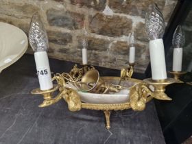 A EMPIRE STYLE SIX LIGHT CHANDELIER, EACH CANDLE SOCKET SUPPORTED ON A SWANS HEAD AND ENCIRCLING