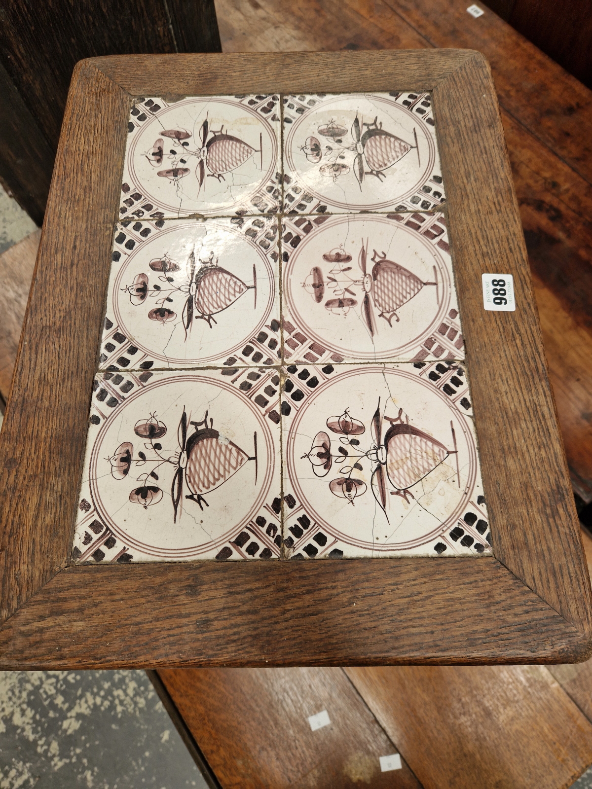 AN OAK COFFEE TABLE INSET WITH SIX DELFT MANGANESE TILES, THE PANEL LEGS PEGGED TO THE STRETCHER. - Image 2 of 4