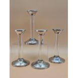 A SET OF FOUR SILVER MOUNTED GLASS COLUMN CANDLESTICKS BY ASPREY, LONDON 2007. H 19cms.