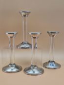 A SET OF FOUR SILVER MOUNTED GLASS COLUMN CANDLESTICKS BY ASPREY, LONDON 2007. H 19cms.