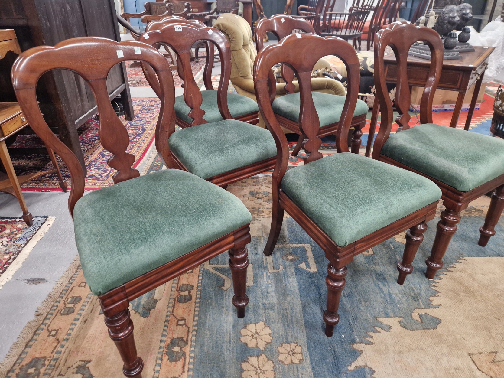A SET OF SIX LATE VICTORIAN MAHOGANY BALLOON BACKED CHAIRS WITH GREEN DROP IN SEATS TURNED