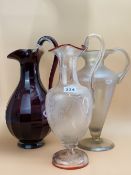 A CLEAR GLASS BALUSTER EWER ETCHED WITH CUPID OVALS AND WITH A CRANBERRY TRAILED RIM AND FOOT, A
