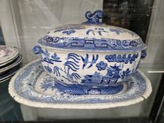A WILLOW PATTERN SOUP TUREEN AND COVER, A BLUE AND WHITE PLATTER, TWO BLUE AND WHITE SOUP PLATES AND
