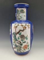 A CHINESE BLUE GROUND VASE PAINTED WITH A RESERVE OF THREE LADIES ON A TERRACE AND WITH GARDEN