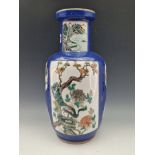 A CHINESE BLUE GROUND VASE PAINTED WITH A RESERVE OF THREE LADIES ON A TERRACE AND WITH GARDEN