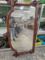 A VICTORIAN MAHOGANY FRAMED OVER MANTEL MIRROR THE S-SCROLL SIDES CARVED WITH FOLIAGE AT THEIR