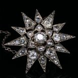 AN ANTIQUE VICTORIAN OLD CUT DIAMOND STARBURST BROOCH. THE BROOCH WITH A REMOVABLE SCREW DOWN 14ct