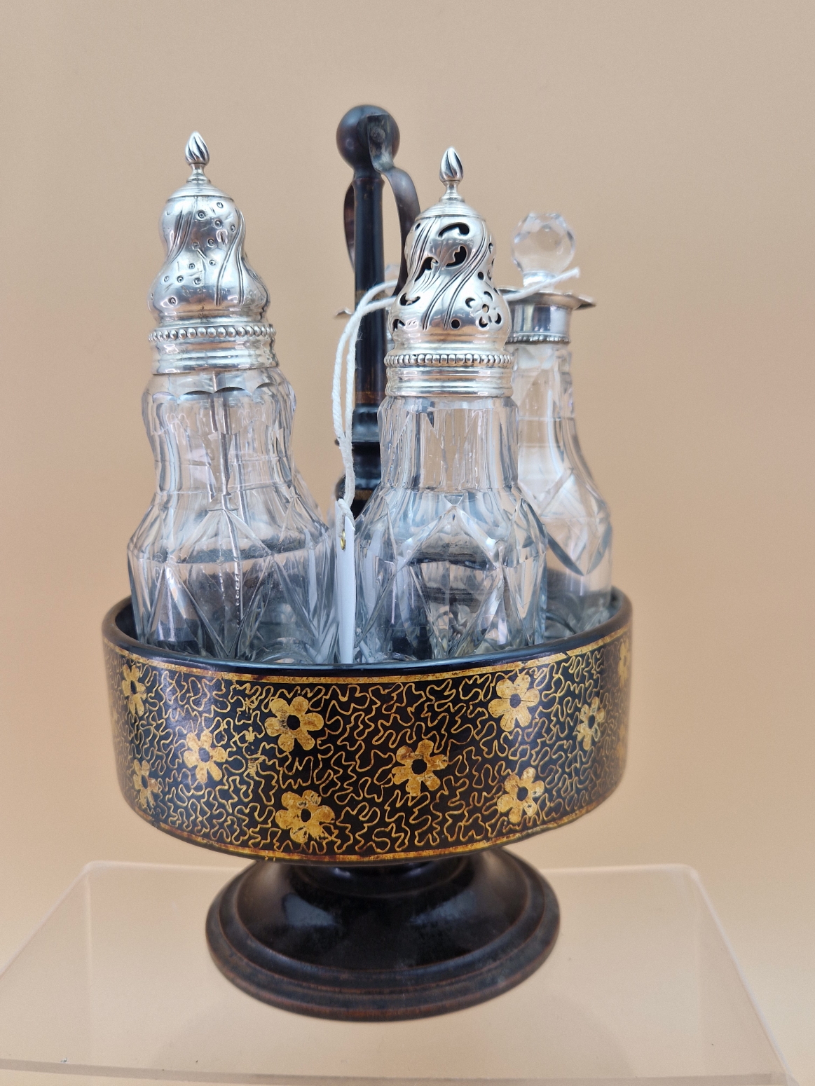 A FLORAL GILT BLACK PAPIER MACHE CRUET STAND WITH FIVE CUT GLASS BOTTLES WITH WHITE METAL MOUNTS, - Image 5 of 8