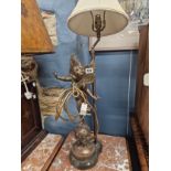 A PATINATED METAL TABLE LAMP FEATURING AN AMORINO STANDING ON A STARRY GLOBE.   H 80cms. A PAIR OF