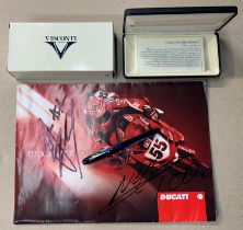 A DUCATI 2005 SALE BROCHURE SIGNED BY CARL FOGARTY TOGETHER WITH A VISCONTI /DUCATI PEN (BOXED)