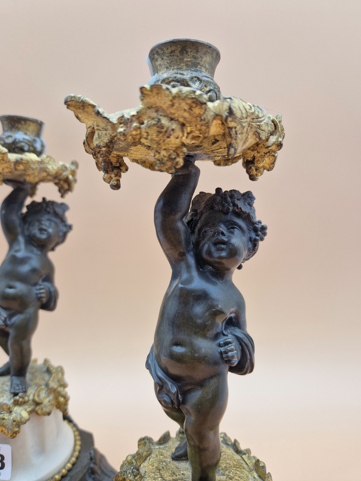 A PAIR OF LATE 19th C. BRONZE, ORMOLU AND WHITE MARBLE CANDLESTICKS HELD UP BY PUTTI STANDING ON - Image 2 of 5