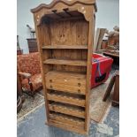 A PINE PANTRY UNIT WITH THREE OPEN SHELVES ABOVE TWO DRAWERS AND A WINE RACK