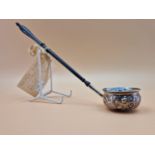 A TODDY LADLE INSET WITH A QUEEN ANNE COIN AND WITH AN EBONY HANDLE