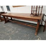 A TEAK AND PINE REFECTORY TABLE, THE CLEATED RECTANGULAR PLANK TOP ON PAIRS OF LEGS TO EACH NARROW