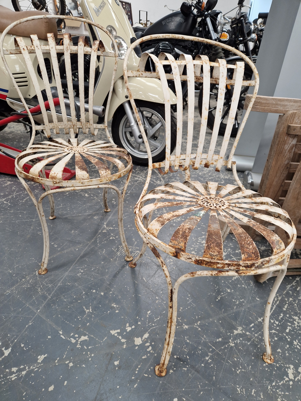 A PAIR OF ANTIQUE FRENCH IRON SPRUNG SEAT CAFE TYPE CHAIRS DESIGNED BY FRANCOIS CARRE LABELLED