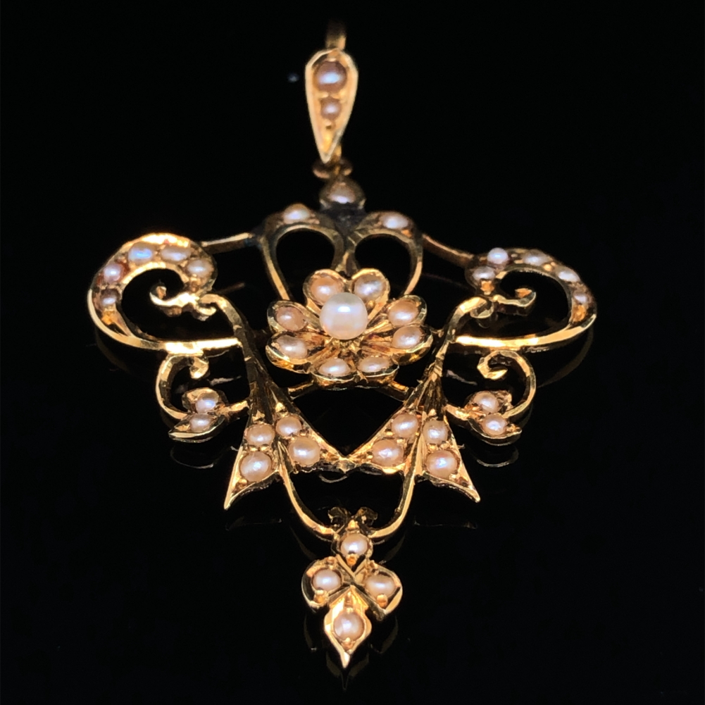 AN ANTIQUE ART NOUVEAU 15ct GOLD AND SEED PEARL. DROP LENGTH INCLUDING BAIL 4.4cms.