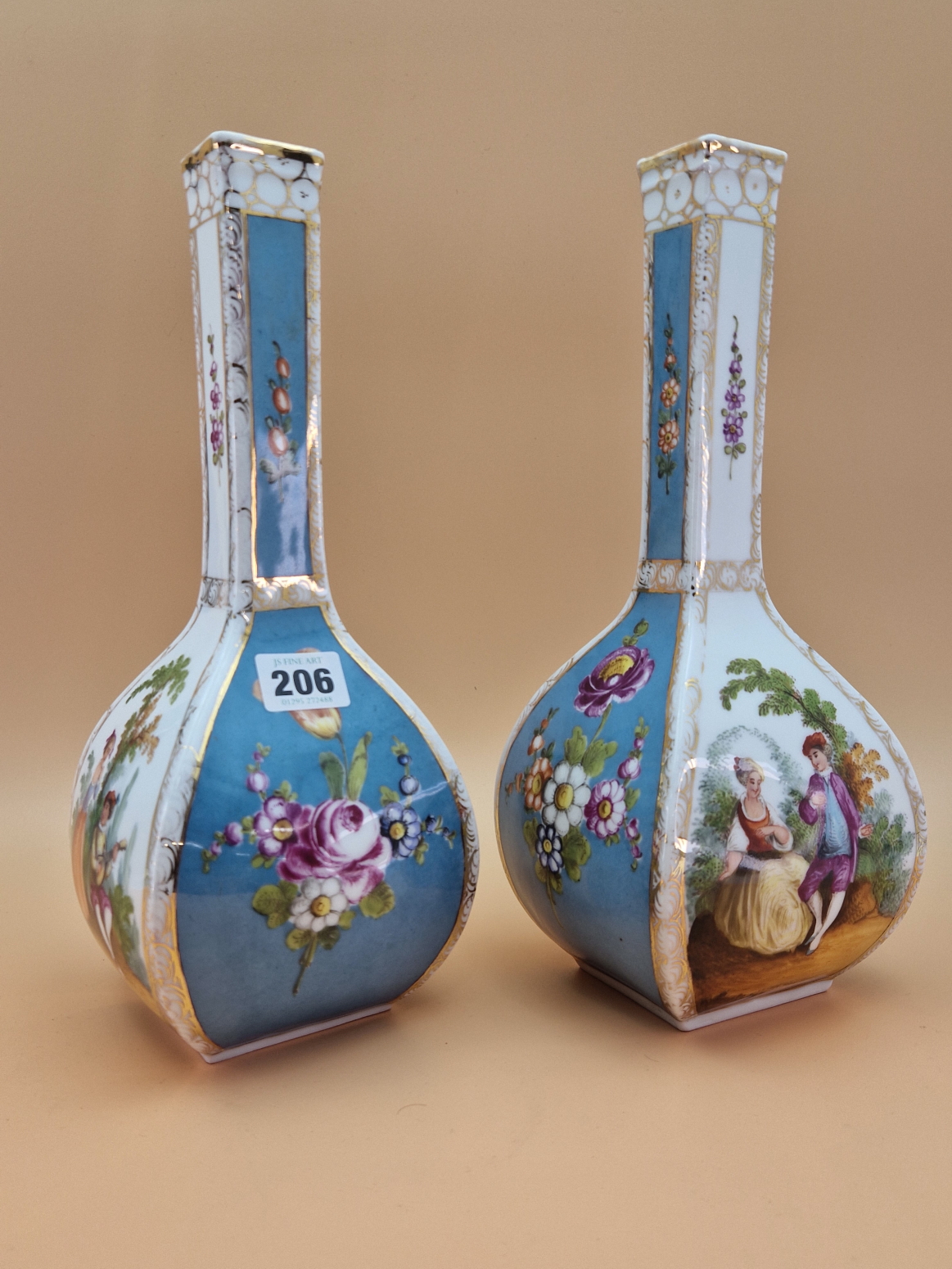 A PAIR OF CROWN DRESDEN SQUARE SECTIONED BOTTLE VASES PAINTED WITH BLUE GROUND FLORAL PANELS