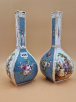 A PAIR OF CROWN DRESDEN SQUARE SECTIONED BOTTLE VASES PAINTED WITH BLUE GROUND FLORAL PANELS