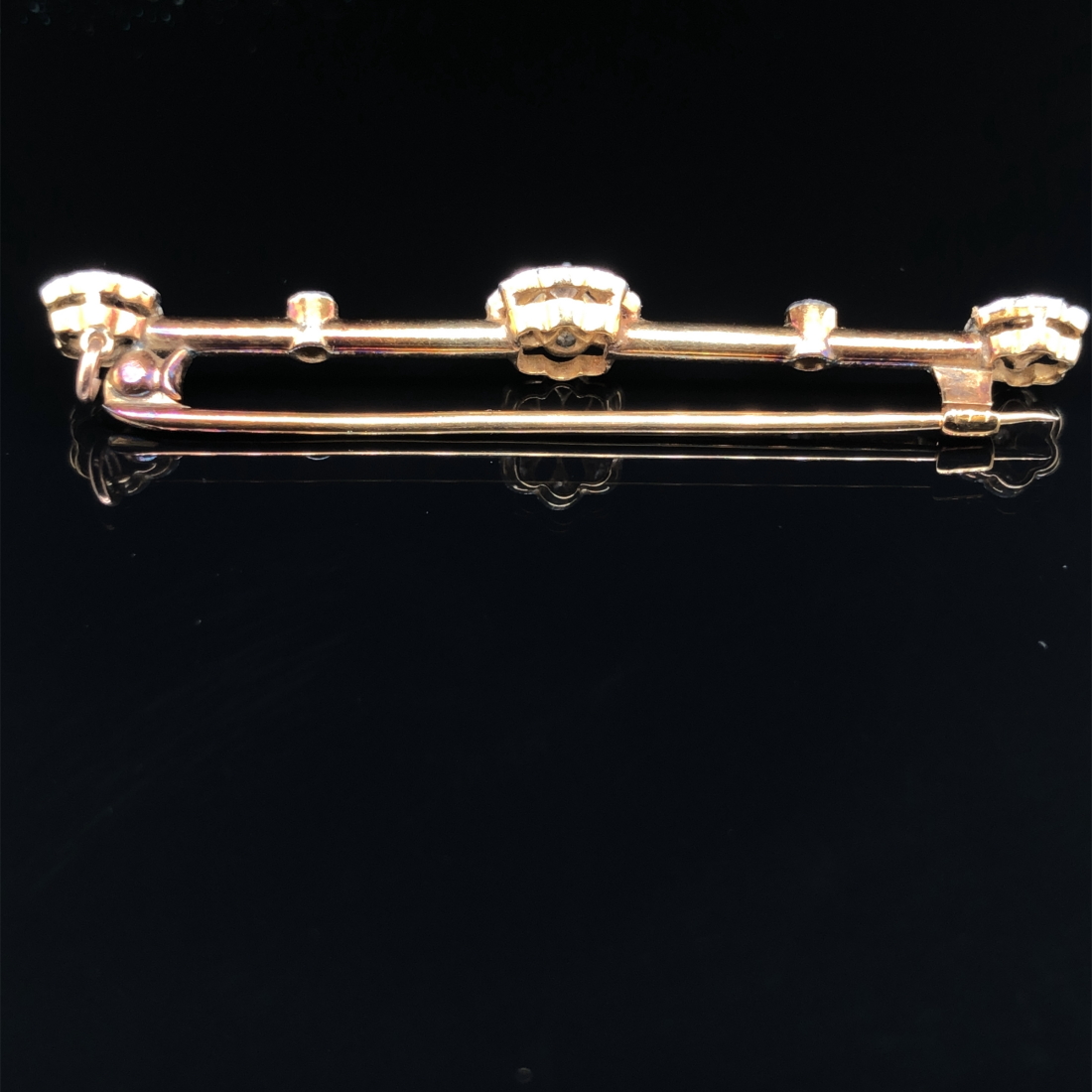 AN ANTIQUE TRIPLE DIAMOND CLUSTER BAR BROOCH. UNHALLMARKED, ASSESSED VARIOUSLY BETWEEN 14-15ct GOLD. - Image 2 of 2