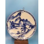 A PAIR OF CHINESE BLUE AND WHITE CHARGERS PAINTED WITH MOUNTAINOUS ISLANDS, A BUFFALO ON ONE AND A